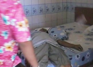 The deceased lying on his bed